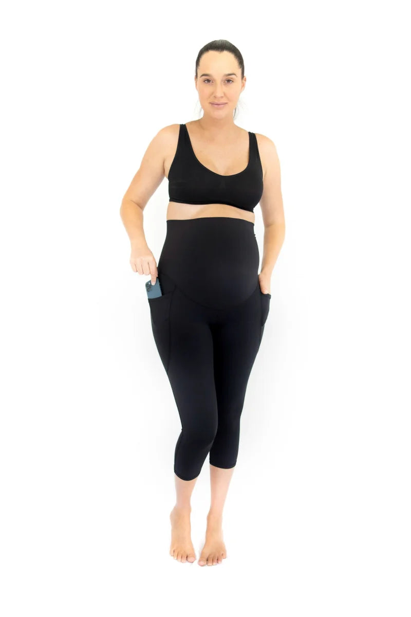 Woman in black maternity leggings with pockets, showcasing completely specialised activewear