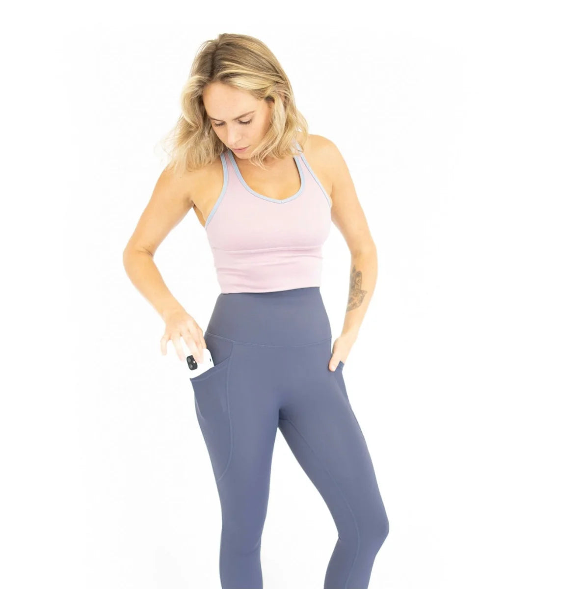 Woman in pink tank top and blue leggings showcasing 3/4 Shaper Move Leggings activewear