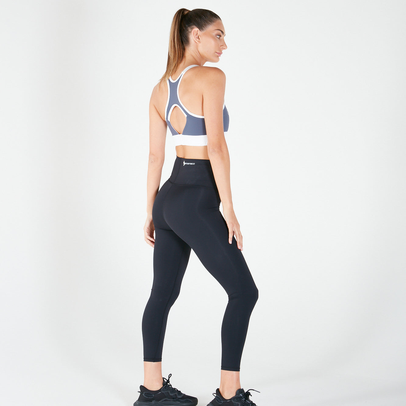 Woman in 7/8 Shaper Move Leggings activewear, showcasing side view and shapewear design