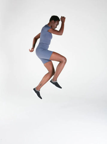 Athletic figure in mid-jump wearing activewear for enhanced performance and style.