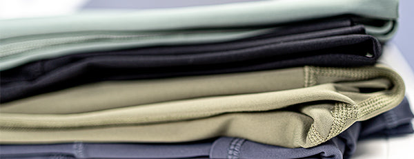 Stack of neatly folded maternity leggings in various colors available online in Australia