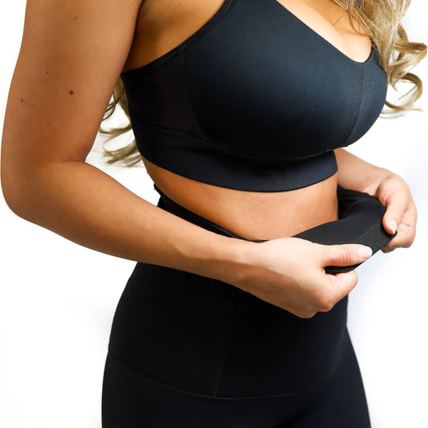 Black sports bra and high-waisted post-pregnancy recovery leggings workout set