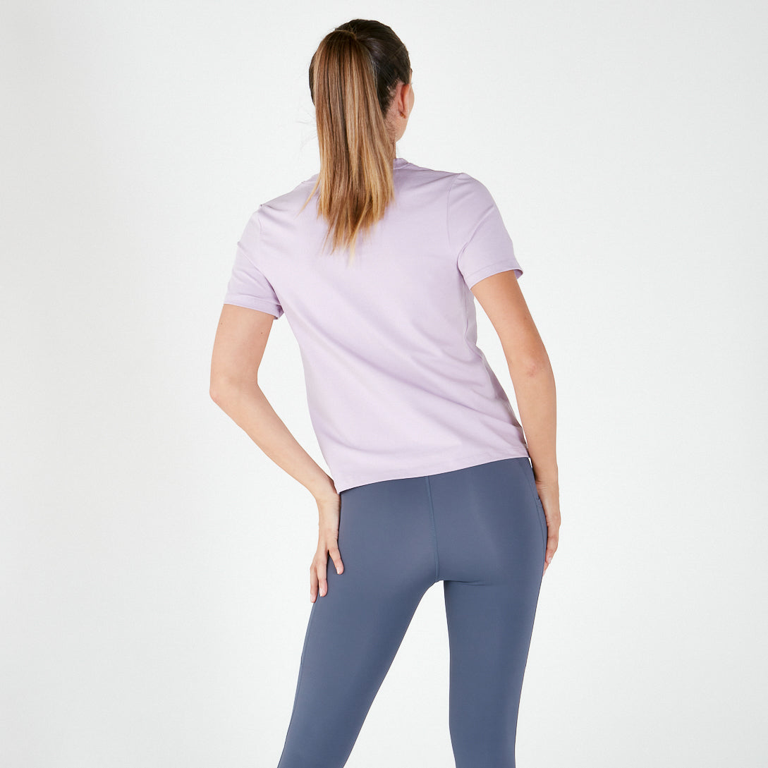 Woman in light purple t-shirt and blue leggings showcasing maternity activewear final sale