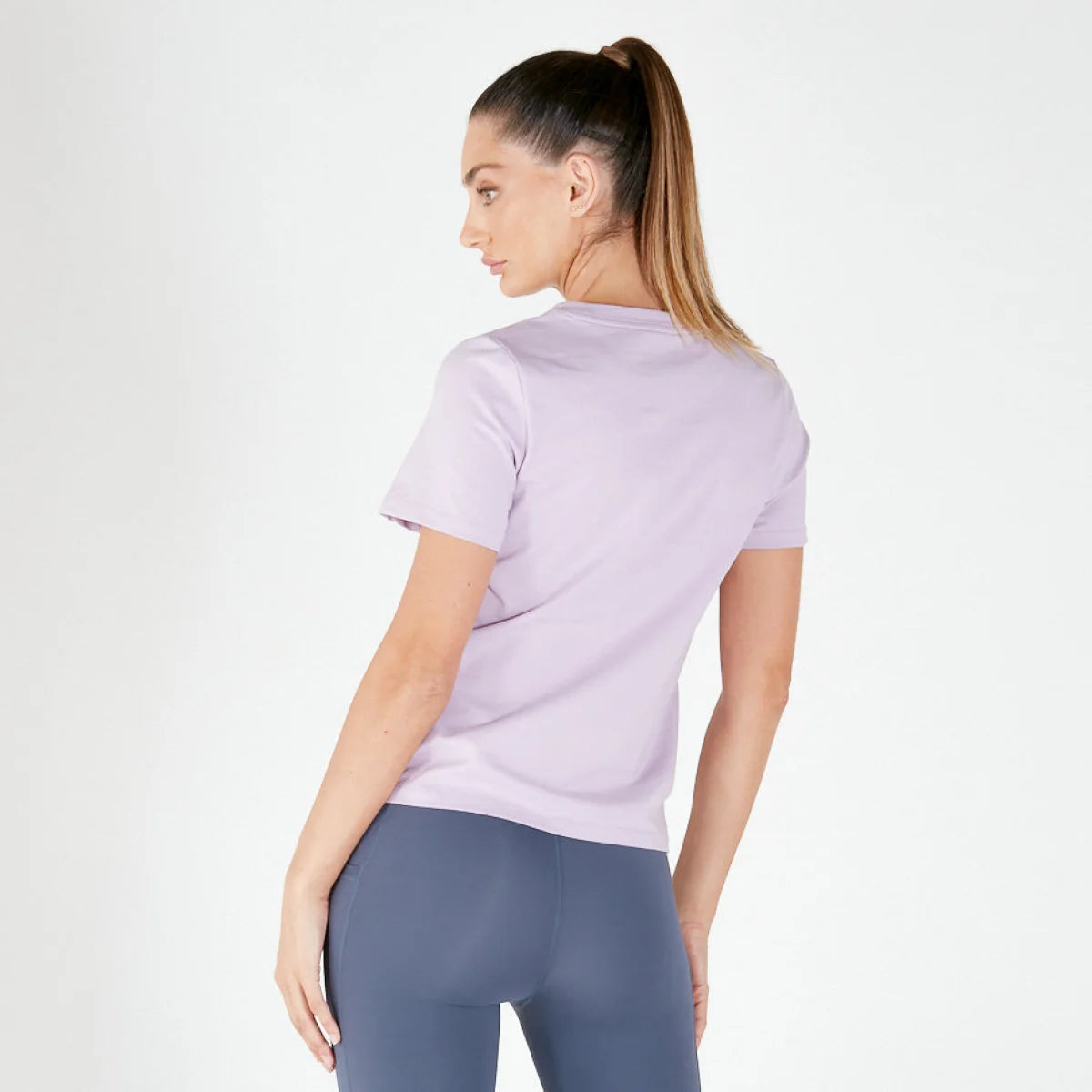 Woman in lavender BASIC TEE and blue leggings, ideal maternity activewear final sale