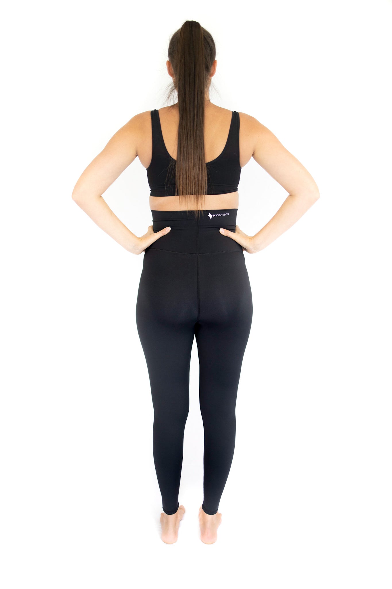 Woman in black workout attire showcasing Emama Maternity Leggings, completely specialised