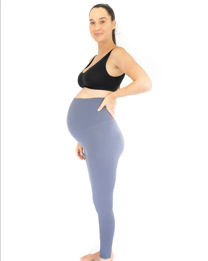 Pregnant woman in a black sports bra and blue Emama Maternity Leggings - Twilight