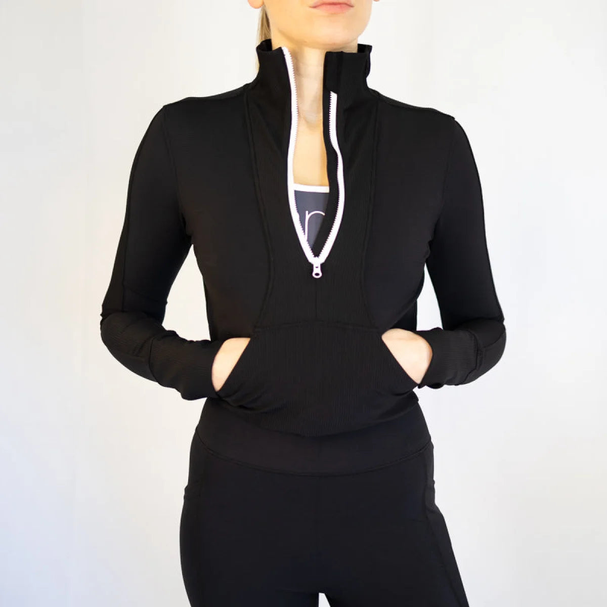 Black athletic zip-up jacket, body hugging design, with high collar and front pockets