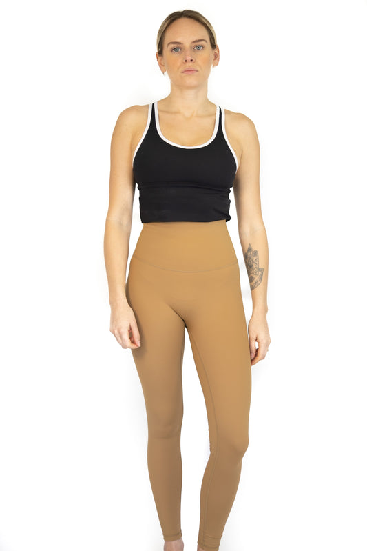 Woman in black crop top and tan Shaper Move Leggings on final sale, limited sizes