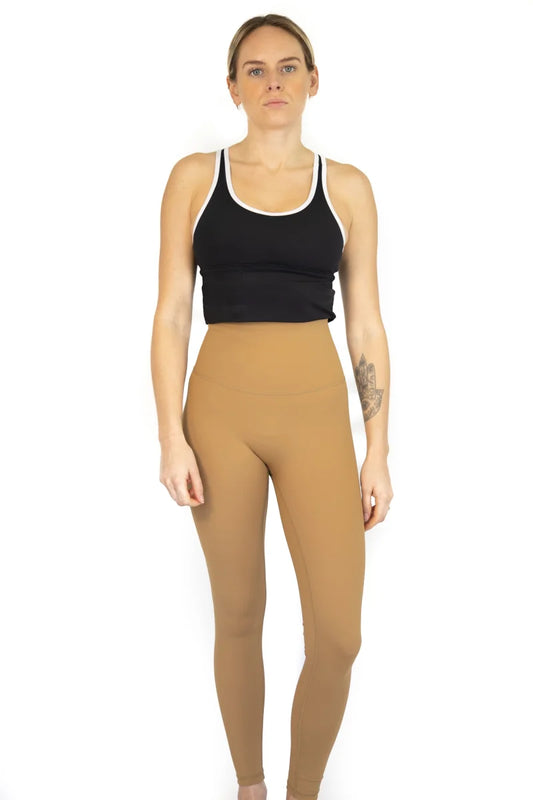 Woman in black crop top and tan Shaper Move Leggings on final sale, limited sizes