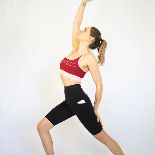 Woman in athletic wear stretching with Shaper Move Long Shorts - perfect for pet hair and maternity