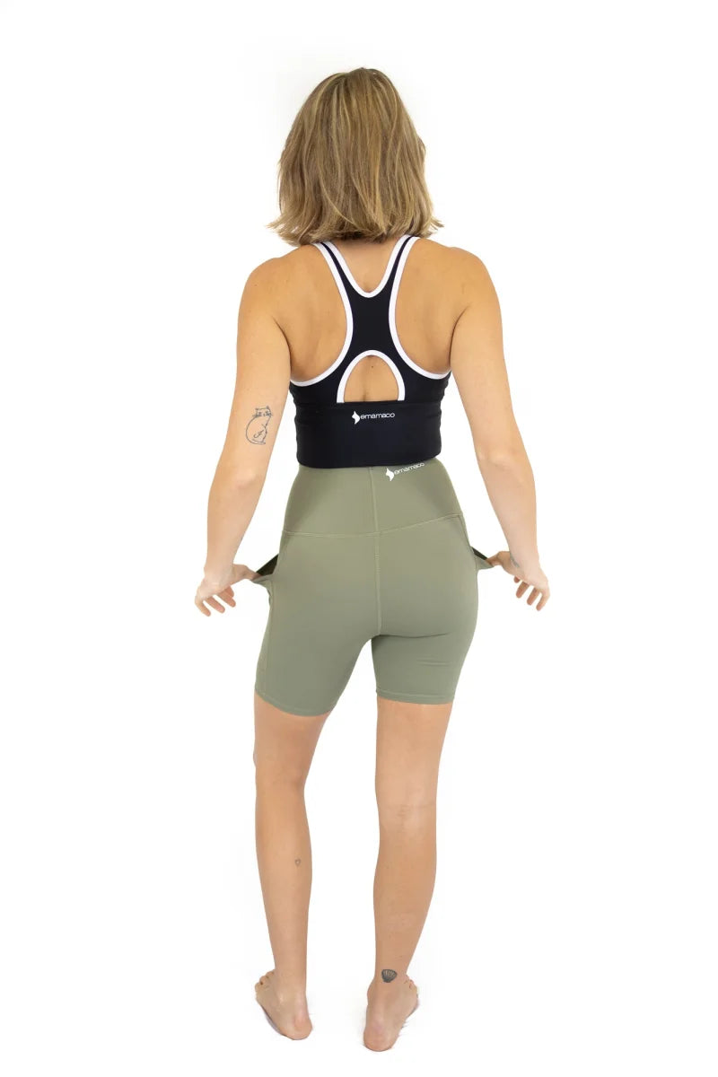 Woman in athletic clothing from behind wearing Shaper Move Shorts in Olive on final sale