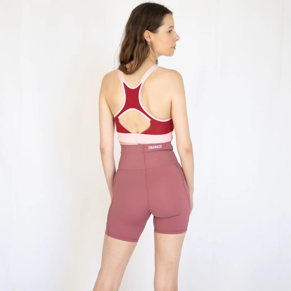 Woman in red sports bra and mauve activewear shorts from Shaper Move, ideal for maternity