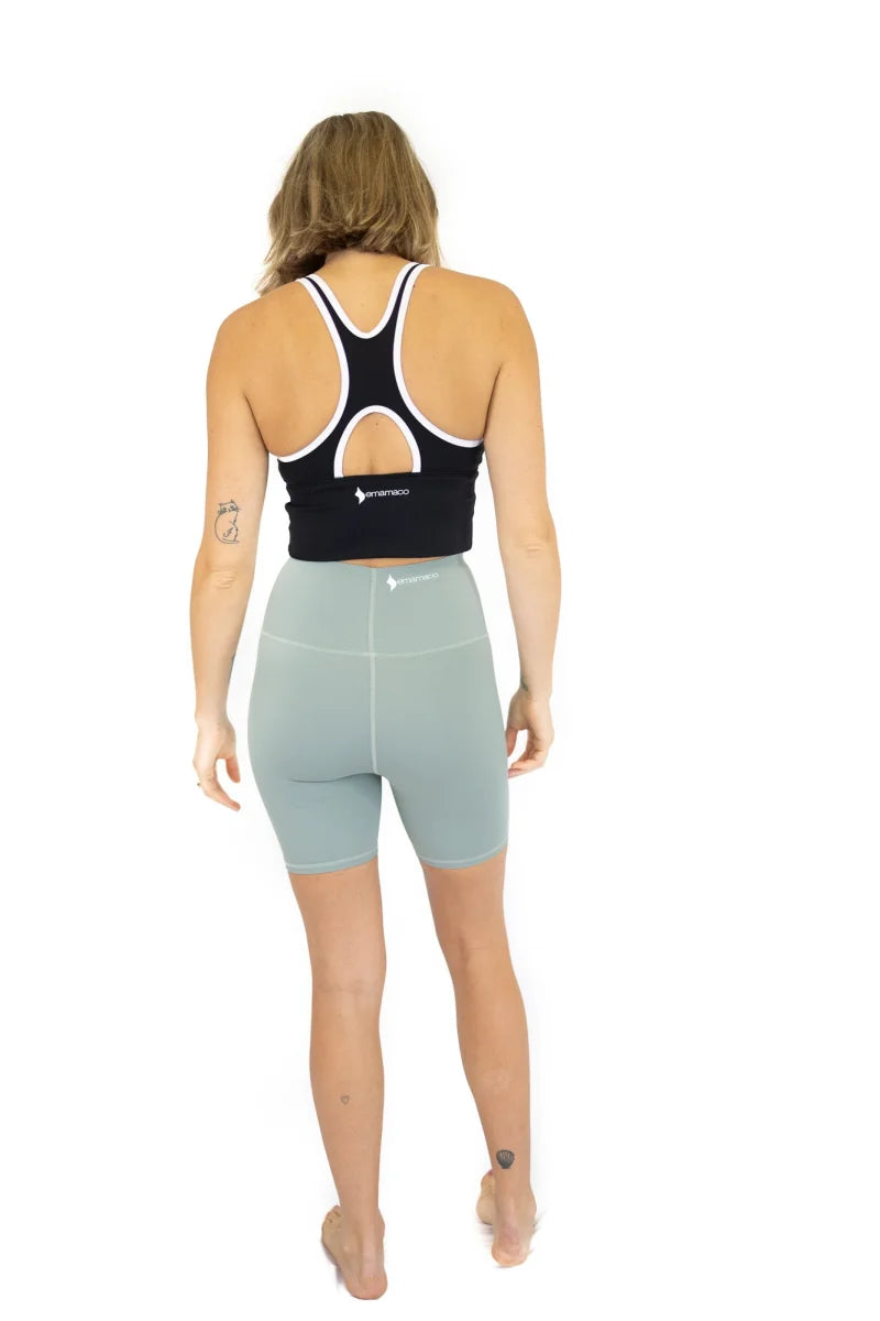 Woman in black sports bra and light blue Shaper Move Shorts on final sale, limited sizes