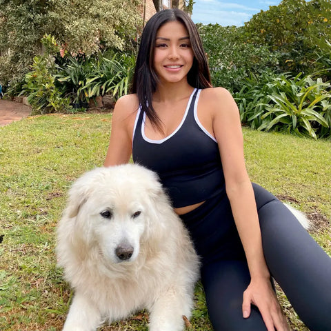 Beautiful white Great Pyrenees dog with fluffy fur and pet hair in women’s health article.