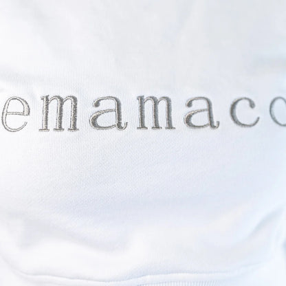 Delicately stitched emamaco logo on a light-colored Snow High Neck Jumper