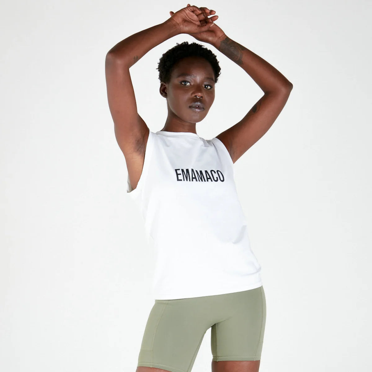 Person in EMANADO tank top and olive green shorts, a stylish addition to activewear