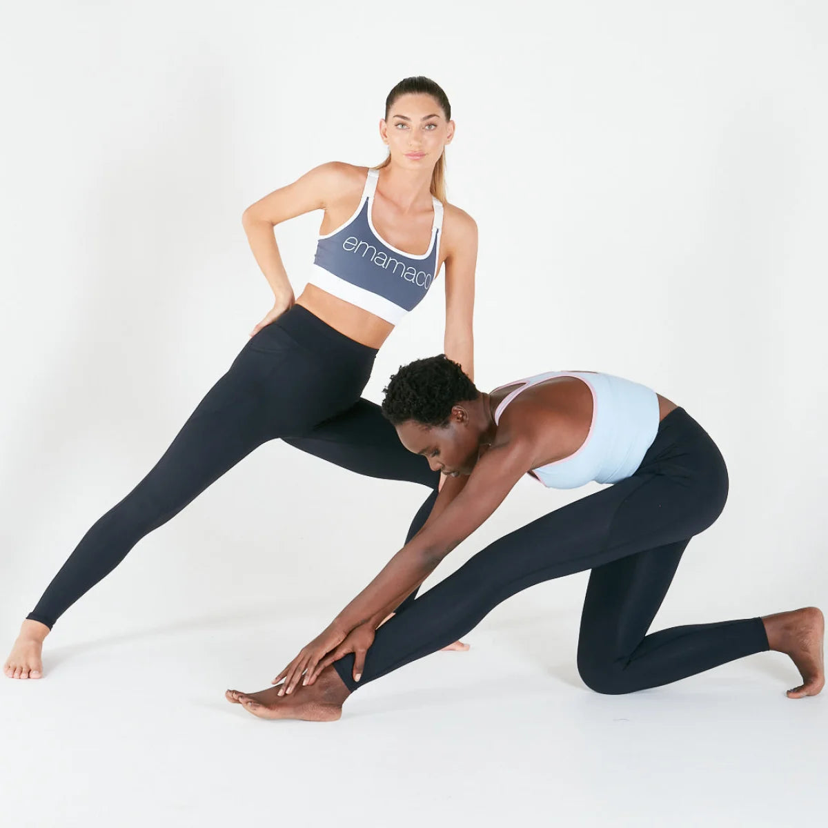 Two women in athletic wear doing yoga in Vibe Leggings with regular fit waistband