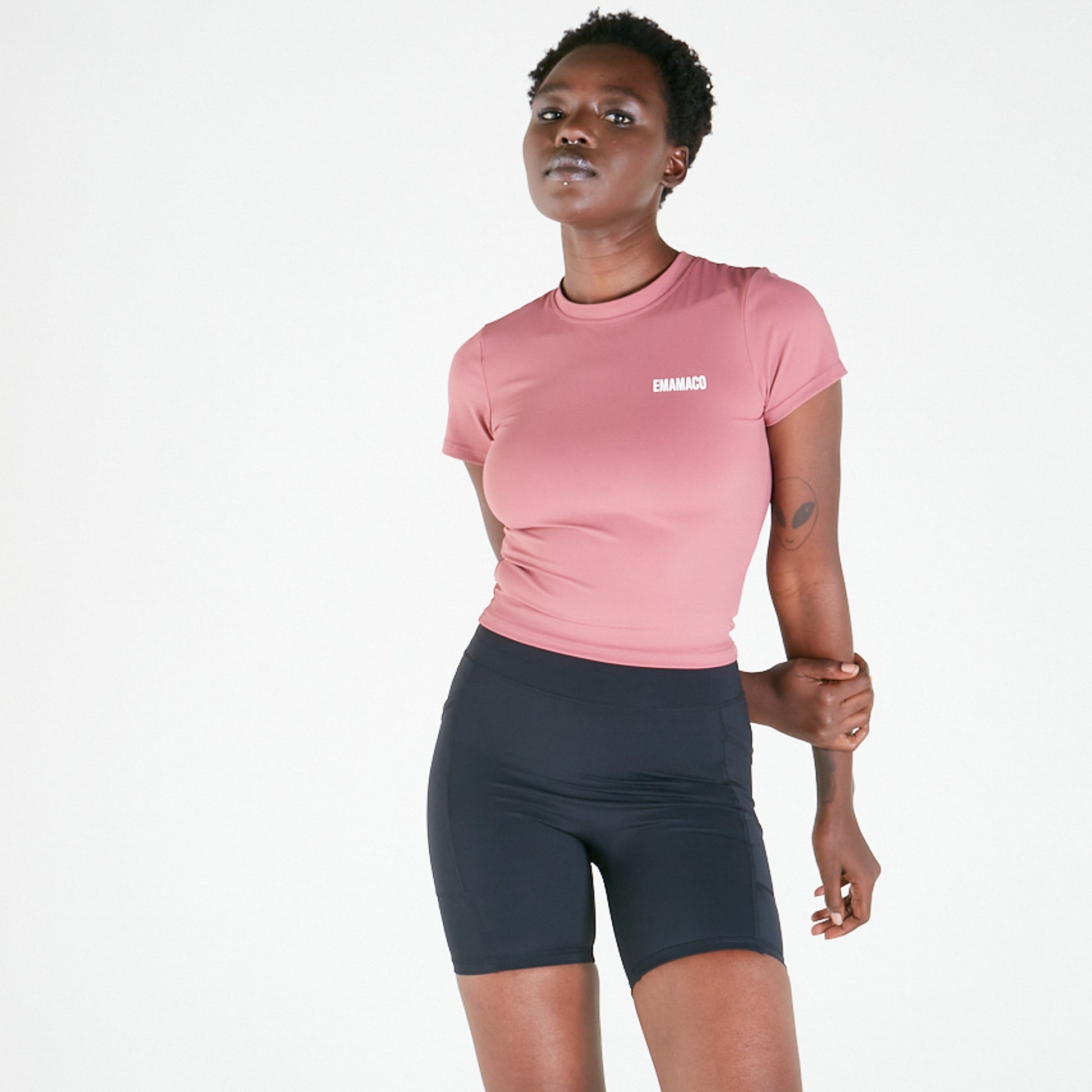 Person in pink t-shirt and dark shorts showcasing Vibe Shorts with regular fit waistband