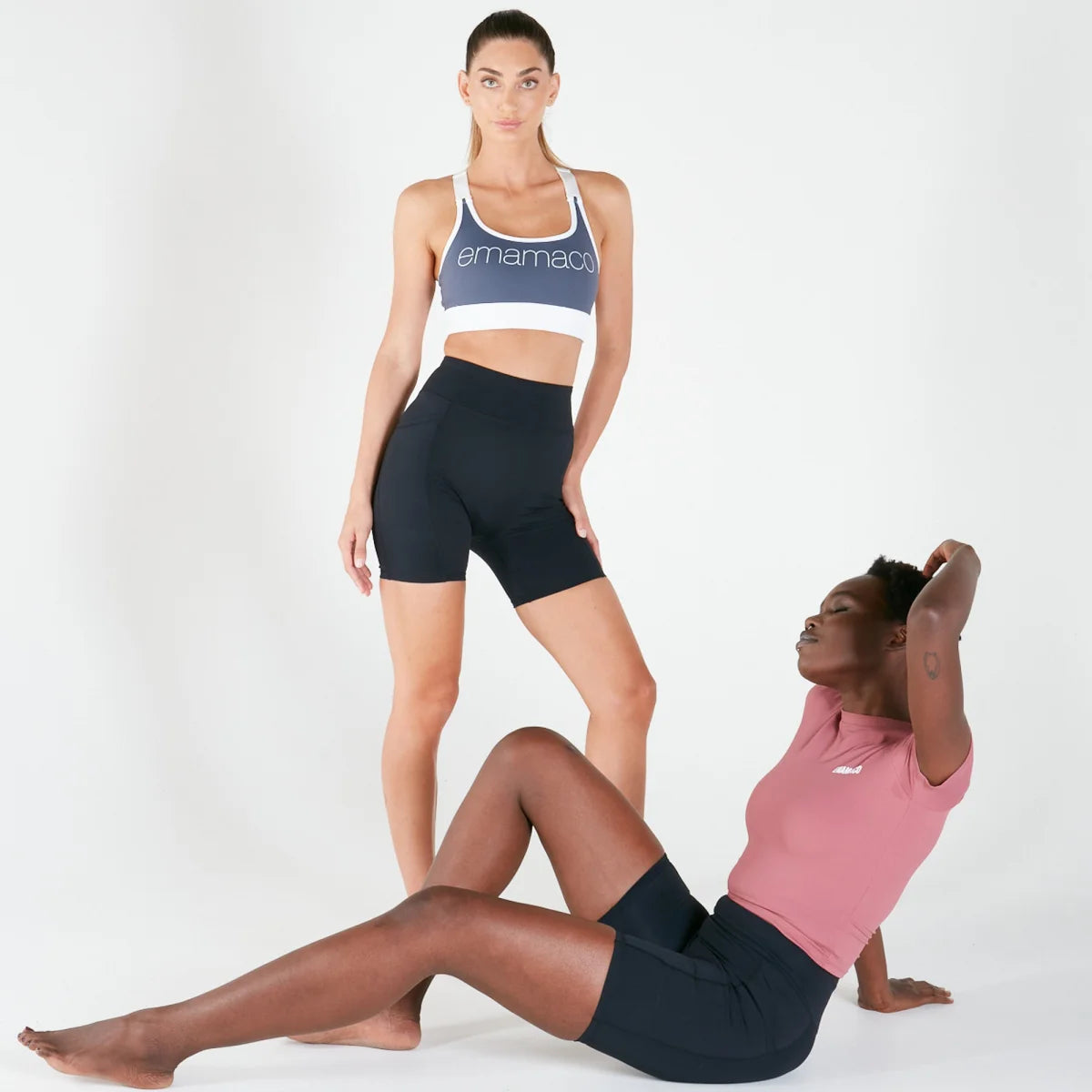 Two women in athletic wear showcasing Vibe Shorts with pockets and regular fit waistband